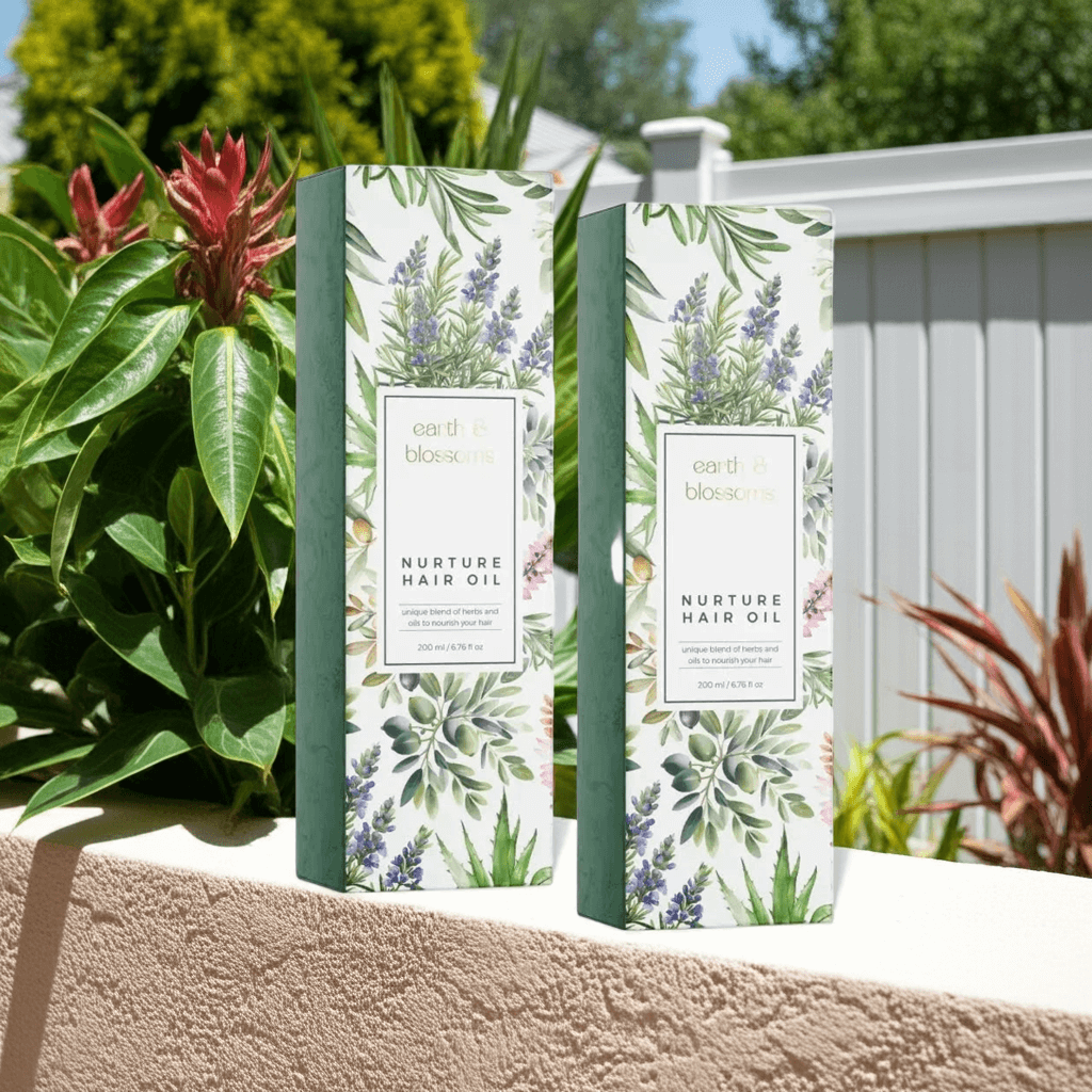 Two boxes of 'Nurture Hair Oil' with botanical designs on a garden background