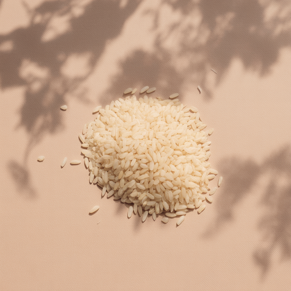 Pile of rice on a beige background with shadow patterns